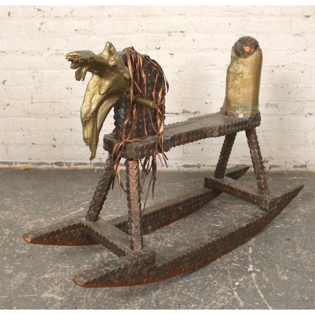 This home made rocking horse features plenty of decoration. Penny clad frame plus a painted driftwood head. Finished with...
