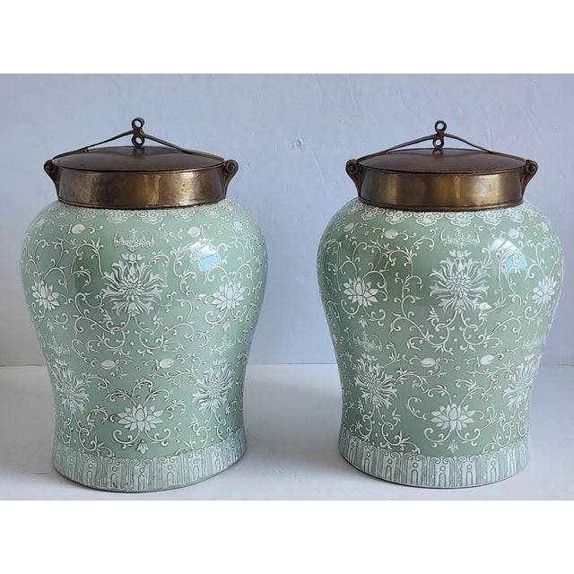 Decorative large scale celadon ceramic ginger jars by Lillian August. Featuring a beautiful enamel painted scrolling motif...