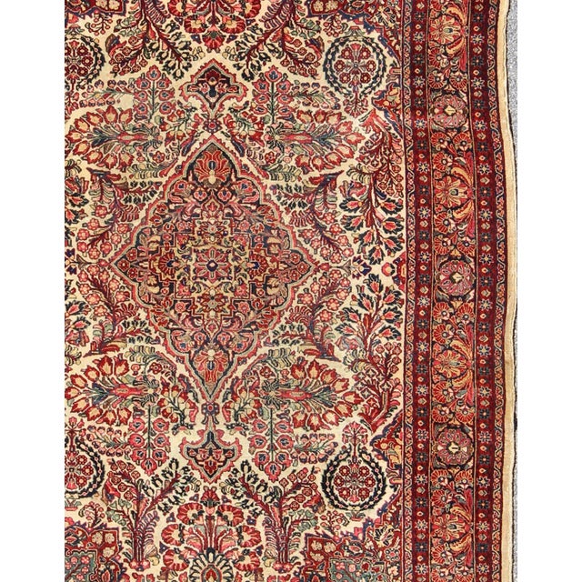 Antique Sarouk Feraghan Fine Persian Rug in Ivory Background on Floral Medallion Design. Country of Origin: Iran; Type:...