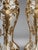A highly decorative pair of late 20th-century Italian Baroque Revival pedestals, finished in an elegant cream tone with...