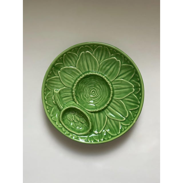 A beautiful green footed platter decorated with the spreading leaves of an asparagus plant with the bud cleverly separated...