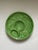 A beautiful green footed platter decorated with the spreading leaves of an asparagus plant with the bud cleverly separated...