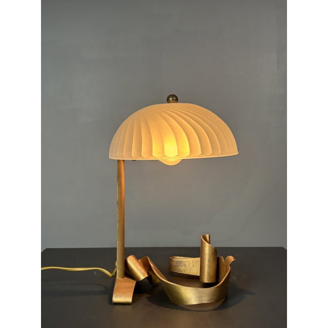 This gorgeous little table or desk lamp was purchased in a French artisan's shop in the late 80s. If it was made then or...