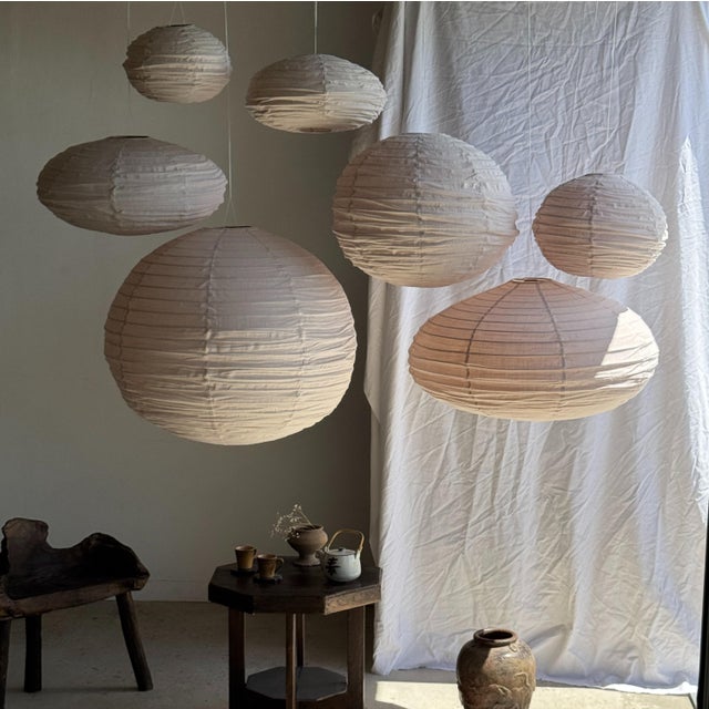 Large round Japanese-style pendant light in pale pink rattan and natural linen. Beautifully handcrafted: natural rattan...