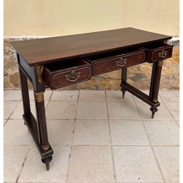 Elegant late 19th to early 20th century French Louis XVI console table crafted in solid oak and enriched with gilt-bronze...