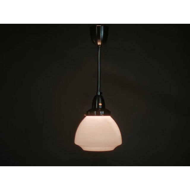 Elegant pair of Art Deco pendant lights, produced in Czechoslovakia during the 1930s. Each pendant features a beautifully...