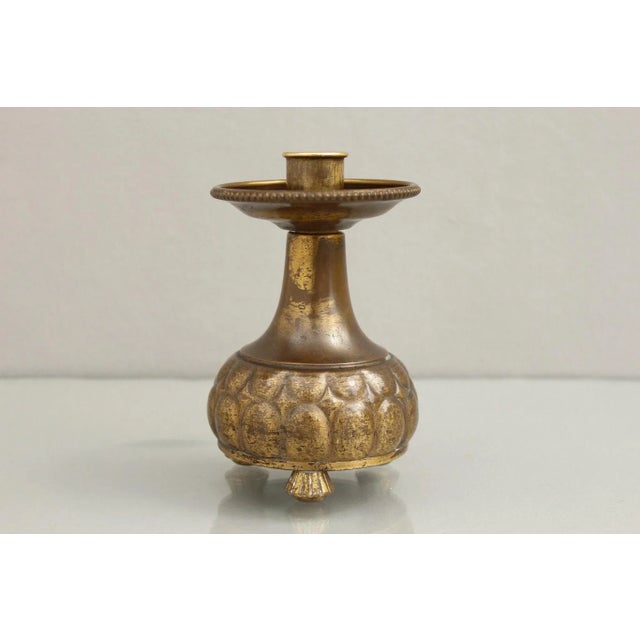 An early WMF brass candlestick, made between 1903 - 1910. Manufacturer's mark: WMF. Good condition with slight signs of...