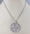 18K White Gold and Diamond Floral Circle Pendant Necklace- This stunning 18K white gold circle pendant features 254 round...