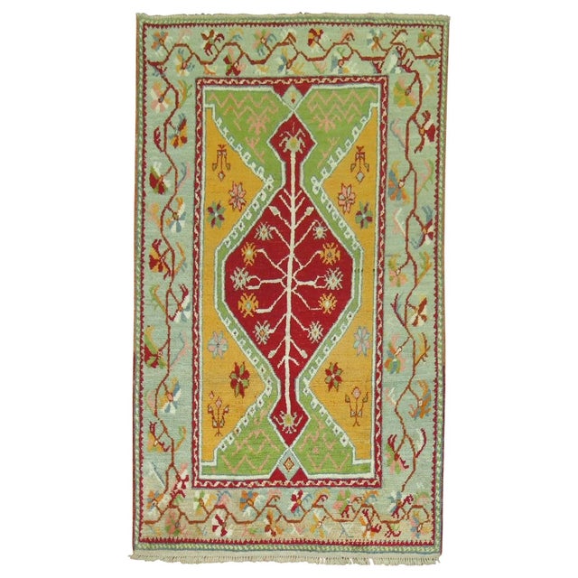Accent size Turkish Ghiordes rug featuring bright vibrant colors. Measures: 3'9'' x 6'.
