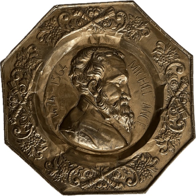 Rare antique brass repoussé wall plaque honoring Michelangelo Buonarroti (1475–1564). This substantial octagonal plaque...