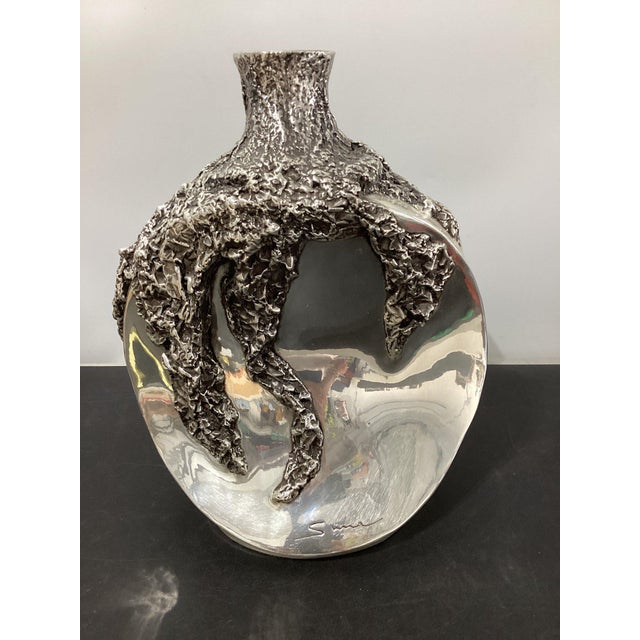 A splendidly designed Concave Flower Vase finished in silver. Designed and handmade in D'Argenta México. Unique piece by...
