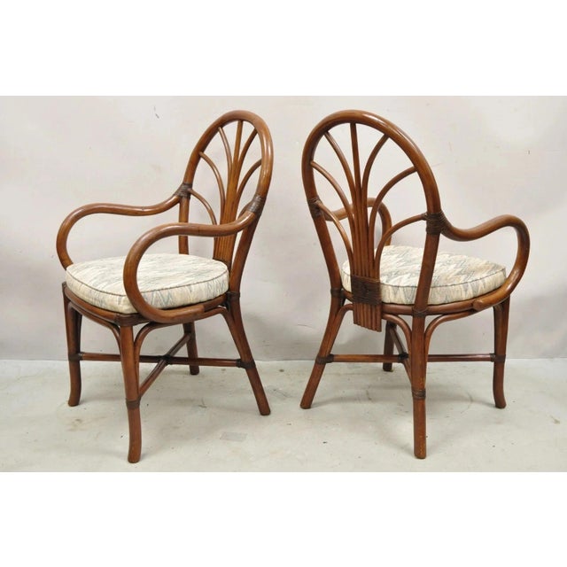 Vintage Hollywood Regency Bentwood Rattan Fan Back Dining Chairs - Set of 4. Circa Late 20th Century. Measurements: 36" H...