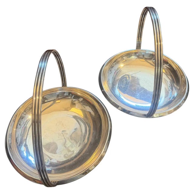 This exceptional pair of 1950s silver-plated centerpieces represents a stunning collaboration between the master of...