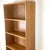 Classic Scandinavian Modern open bookcase crafted in warm teak veneer, featuring five spacious fixed shelves within a...