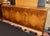 Vintage Roche Bobois lacquered burl wood credenza. Features 3 doors with 8 concealed drawers and shelves at the center....