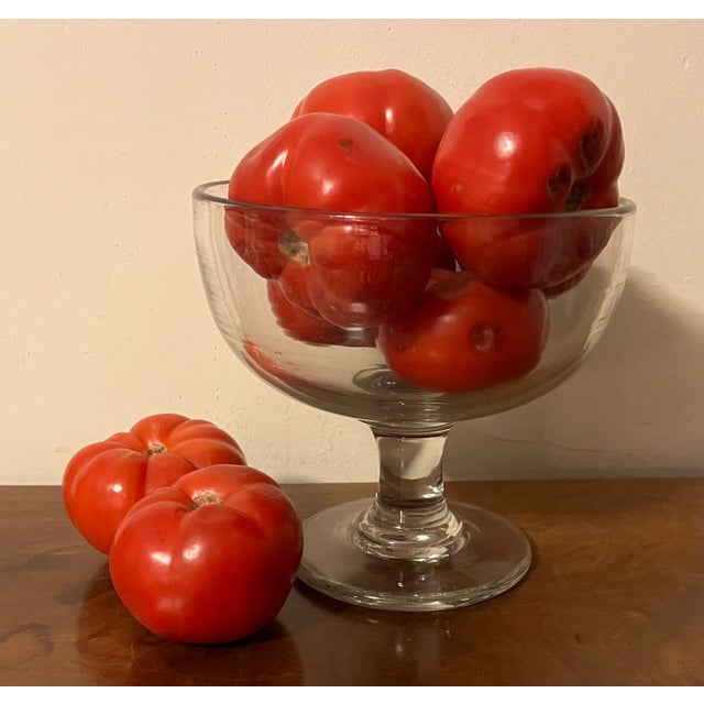 American flint glass footed fruit bowl. Beautiful wavy quality to the glass; polished pontil on the base. Measures 8 1/2"...