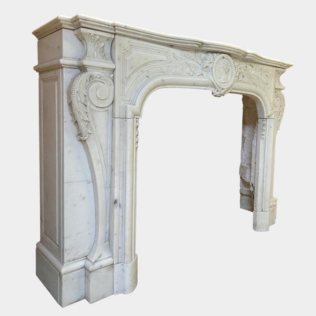 An incredibly well carved Baroque chimney piece executed in Italian Statuary white marble, in the Louis XIV manner circa...