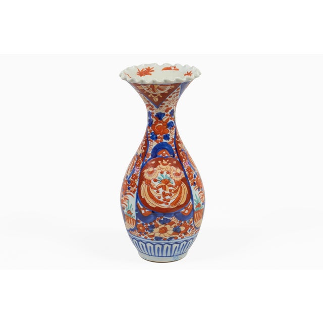A wonderfully baluster shaped antique Japanese Imari vase, with flared narrow neck and scallped rim decorated in bold...