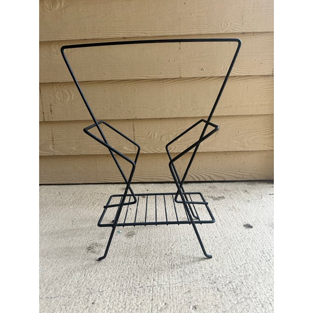Mid-century magazine rack produced in the 1950s.