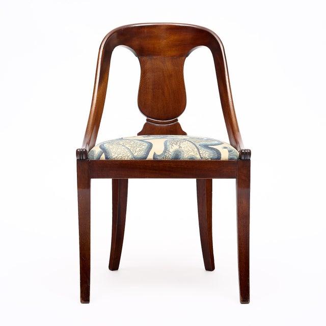 Set of eight dining chairs from France in the Empire style. This set is made of Cuban flamed mahogany and has been...