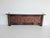 Decorative wall-mounted coat rack, suggest oak or similar hardwood, dating to the early 20th century, circa 1890–1925. The...