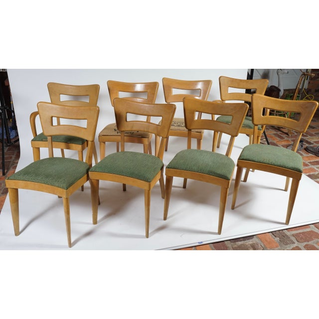 These vintage dining chairs are Heywood-Wakefield model M154 "Dog Bone" chairs, featuring a blonde maple finish and unique...