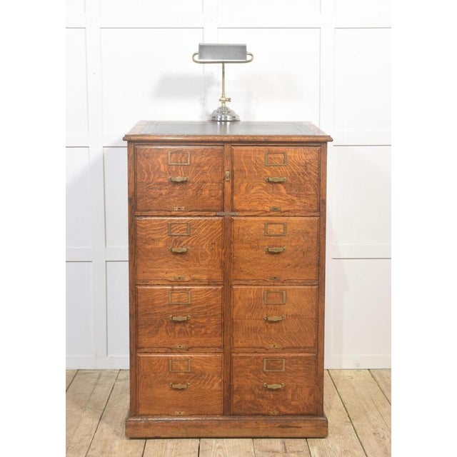 A substantial and well-constructed early 20th century oak filing cabinet, showcasing classic Arts & Crafts–era utility and...