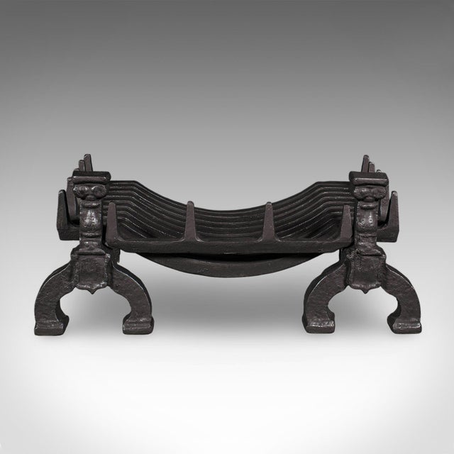 This is an antique fireplace hearth set. An English, heavy cast iron fire basket and andirons, dating to the Victorian...