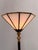 Bring timeless elegance into your interior with this vintage torchiere floor lamp. Featuring a sleek black metal stem,...