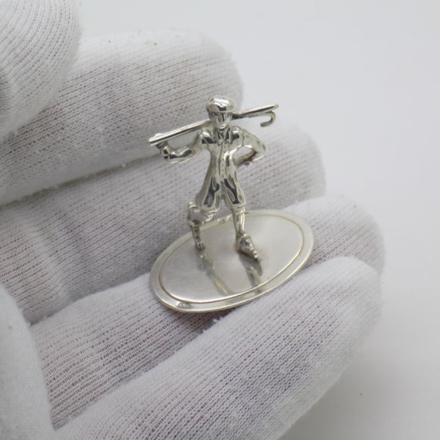 A vintage miniature depicting a gentleman with a walking cane, handcrafted in 835/000 silver in the netherlands in 1978,...