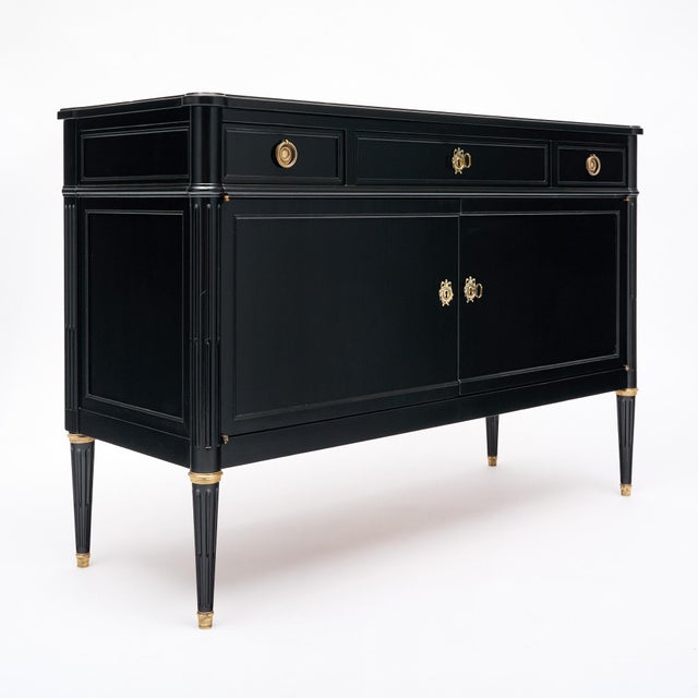 Buffet from France in the Louis XVI style. This piece is made of solid wood construction, primarily mahogany. It has been...