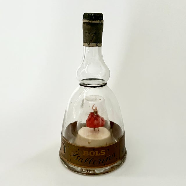 This vintage glass vessel, commonly referred to as a 'Bols Ballerina' bottle, features a dual-chamber glass construction....