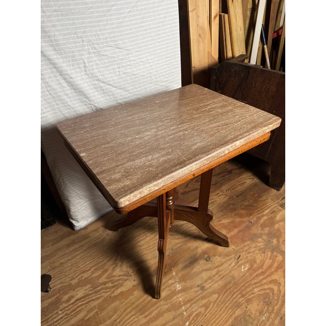 Antique marble top side table in tan Carrera Marble with oak wood base. Possibly 19th century and by the brand Eastlake....