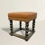 This early 20th-century American stool exudes timeless charm with its Tudor-inspired design updated for modern living....
