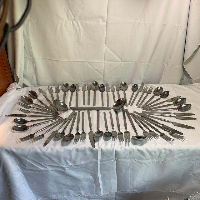 Offered is a 54 piece set of modernist Copenhagen Cutlery by Erik Herlow in the iconic "Obelisk" pattern. This...