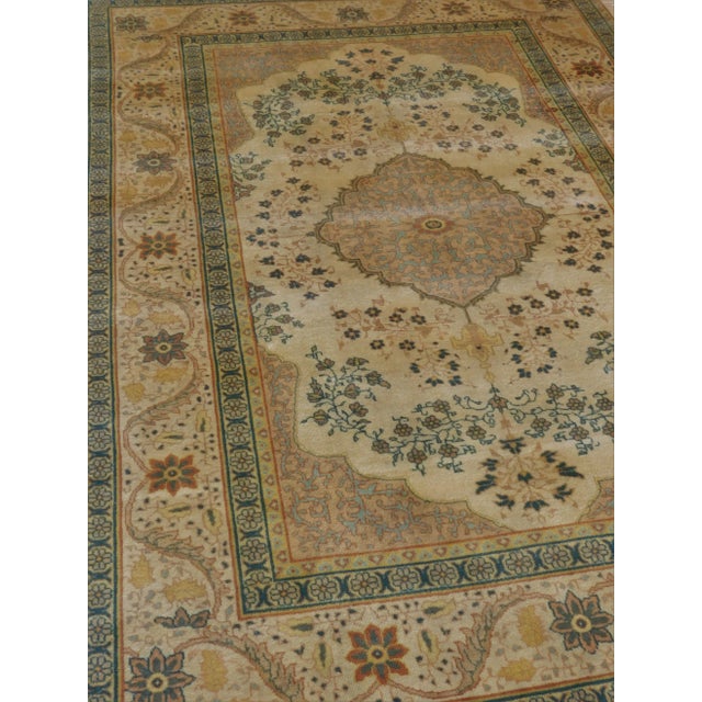 Soft color palette displaying a central medallion, surrounded with floral sparay within spandrels. Border with flower...