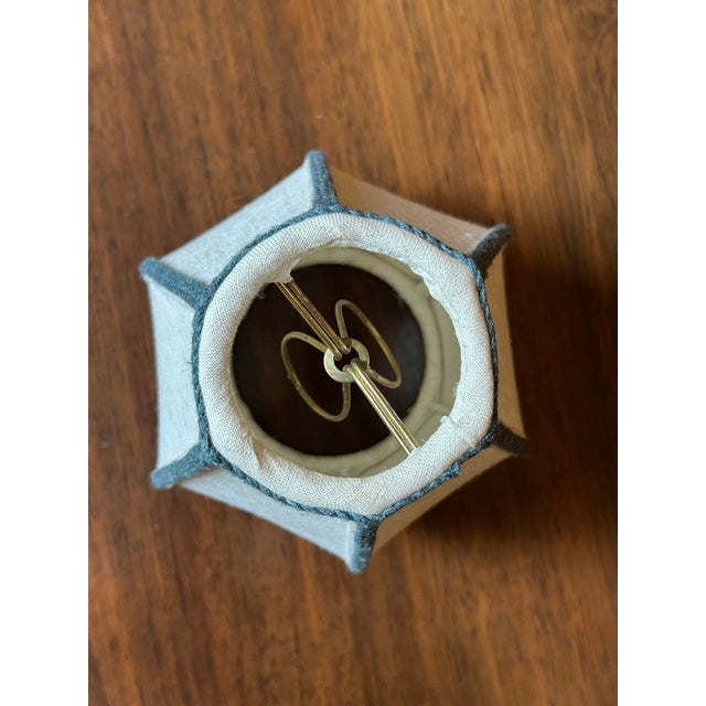 Custom candle clip "Scania" hexagon shape lampshade in a natural-colored linen fabric with peacock blue braided trim on...