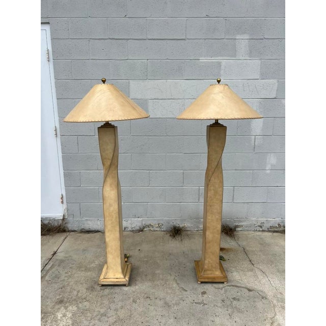 A stunning pair of cream leather–wrapped floor lamps handcrafted for Lexington Furniture Industries in 1996, produced by...