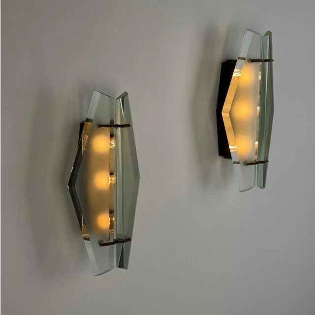 A rare and atmospheric pair of wall lights, model 1937, designed by Max Ingrand for Fontana Arte in the late 1950s — an...