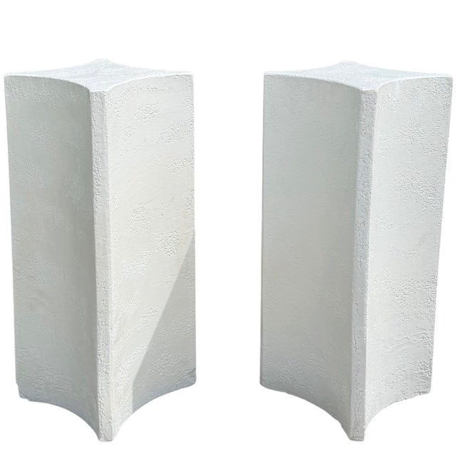 A striking pair of vintage sculptural postmodern pedestal bases crafted of textured white plaster. Their bold...