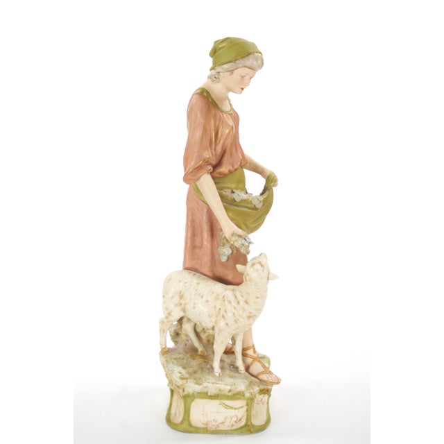 This exquisite early 20th-century porcelain sculpture by Royal Dux showcases the fine craftsmanship and artistic detail...