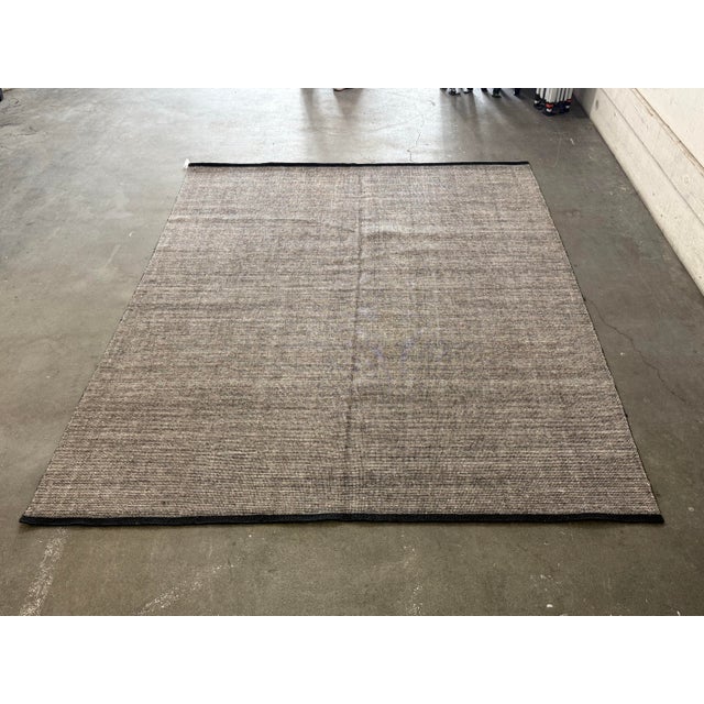 Design Plus Gallery presents a 9ft x 12ft Contemporary Textured Wool Area Rug. The rug has a tightly woven surface in a...