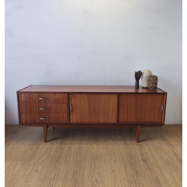 Modernist long sideboard from the 1970s. A simple, minimalist chest of drawers. Original condition. Not renovated. Minor...