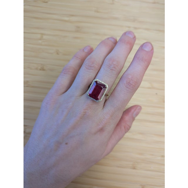 Make a bold statement with this captivating Madagascar Ruby ring. The vivid red center stone is framed by a halo of...