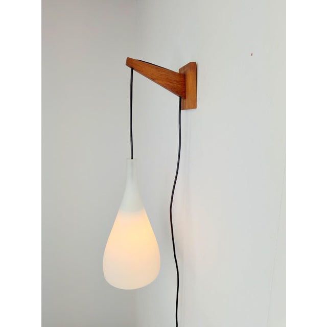 Vintage Tear Drop Wall Lamp in Teak and White Glass, Denmark, 1960s, in Flawless conditions. Designed 1960 to 1969...