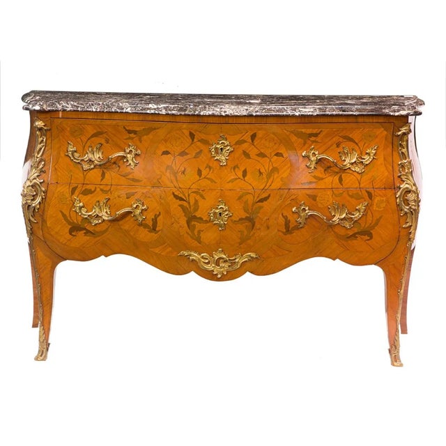 A very elegant late 19th century Louis XV style gilt-bronze mounted marquetry inlaid bombe commode, having a shaped...