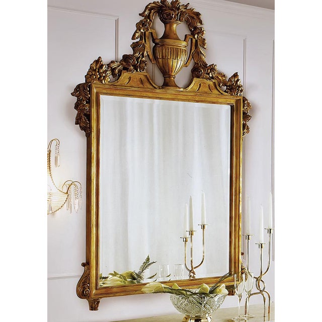 Hand crafted in Italy from solid beech wood, this wall mirror features a hand-carved frame finished in 24-karat gold leaf....
