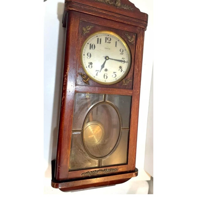 Antique French Vedette wood wall clock with Westminster Chimes. It has a solid oak case with brass applied decoration, a...