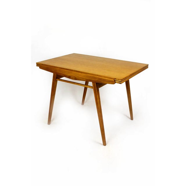 This ash veneer foldable dining table has been produced in the mid-1960s. The table has been restored, varnished in a...