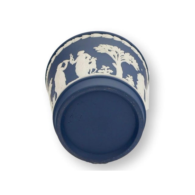 Rare Wedgwood Jasperware cachepot in Portland blue with beautifully modeled cream neoclassical relief decoration. An...